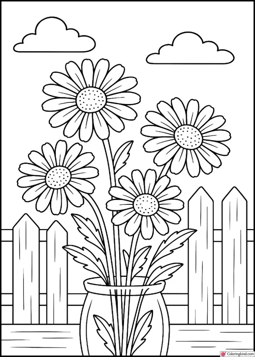 Daisies blooming beside a wooden fence